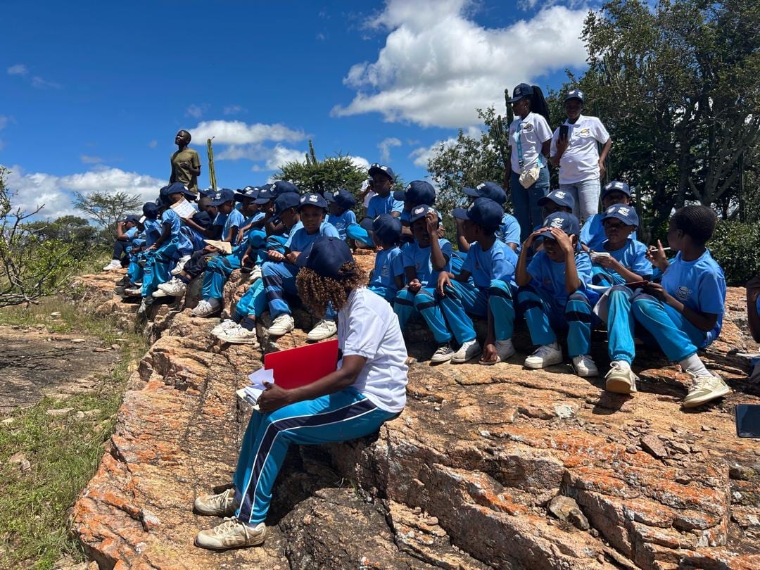 Pupils and teachers having an outdoor lesson on the granite hills outside Bulawayo